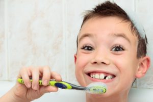 Seven years boy is brushing his teeth
