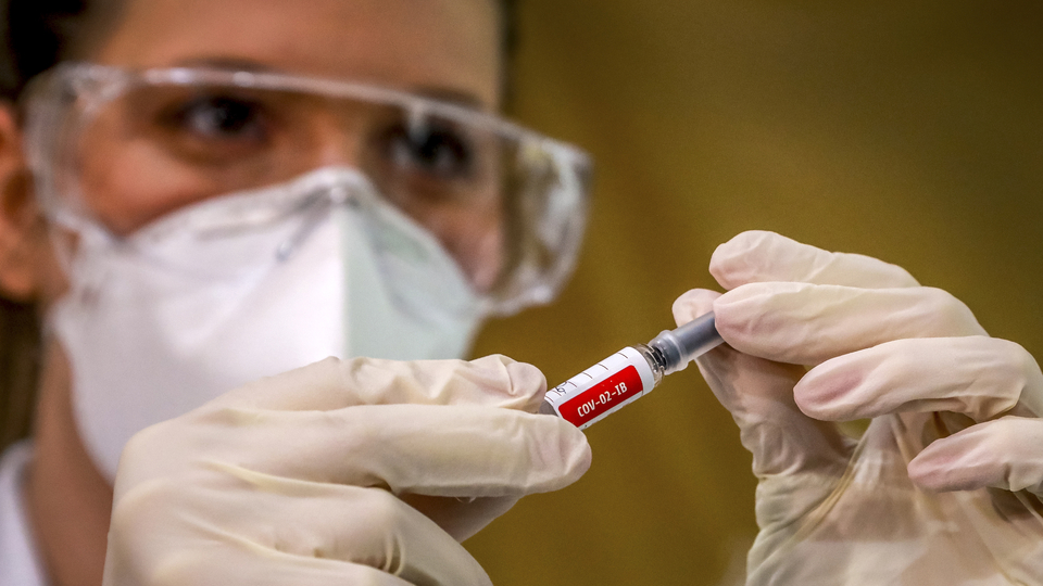 A nurse shows a COVID-19 vaccine produced by Chinese company Sinovac Biotech at the Sao Lucas Hospital, in Porto Alegre, southern Brazil on August 08, 2020. - The vaccine trial is being carried out in Brazil in partnership with Brazilian Research Institute Butanta. (Photo by SILVIO AVILA / AFP)